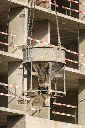 Machine with concrete. Construction of a new residential complex for young families. Concept business, real estate, mortgage. Sunny clear day. Outside.の写真素材