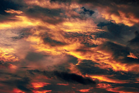 Incredibly picturesque sky in dark blue, red, yellow tones. divinely beautiful. heavy cloud. The warm summer season.の写真素材