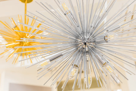 Close-up of a switched off incandescent lamp in a ceiling with a clear glass chandelier in the form of a modern style tube. indoors.の写真素材
