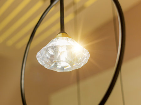 Luminous included round LED lamp with sparkling crystal and metal ring in the interior on the ceiling. close-upの写真素材