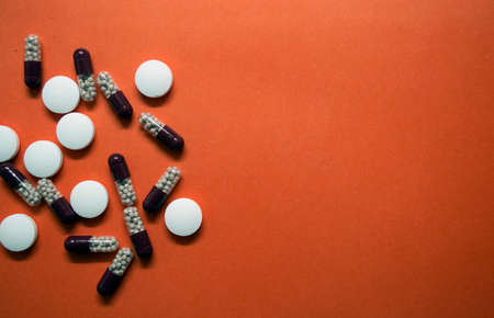different pills are scattered on the tableの写真素材