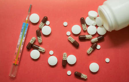 different pills are scattered on the tableの写真素材