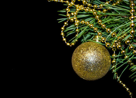 Christmas tree toys on a black background and a fir twigの写真素材
