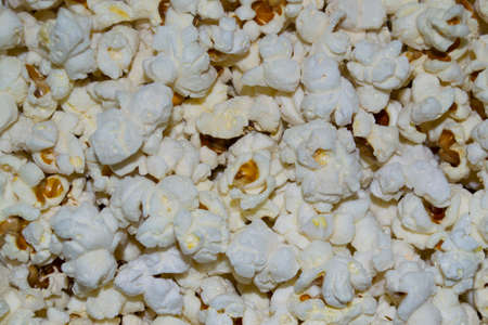 uncovered popcorn grains close-up in a frying pan