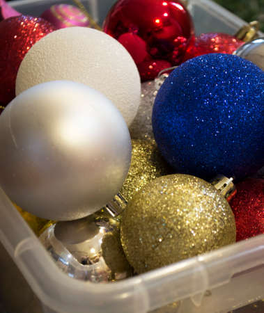 there are a lot of colorful Christmas balls in a box of different sizesの写真素材