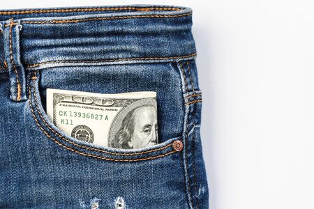 American dollar banknote in a pocket of blue jeans, franklin watching from pocket copy spaceの写真素材