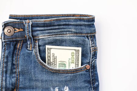 American dollar banknote in a pocket of blue jeans, franklin watching from pocket copy spaceの写真素材