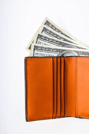 Wallet with dollars banknotes isolated on white background, copy space, one hundred american moneyの写真素材