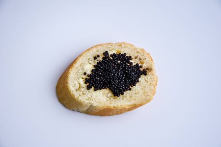 one sandwich with black caviar isolated on the white background Luxurious culinary delicacyの写真素材