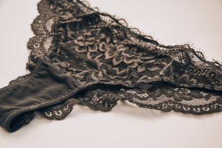 Beautiful female lacy black panties isolated on white background. Sexy underwear,