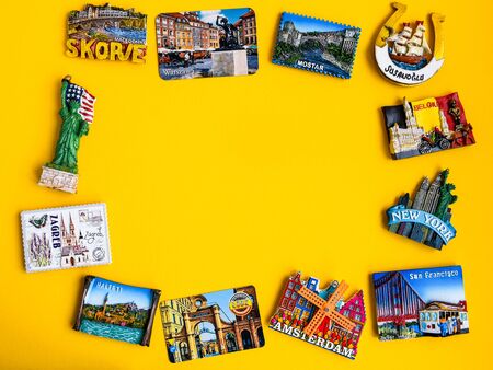 Magnets from different countries on yellow background, travel concept, planning trip, copy spaceの写真素材