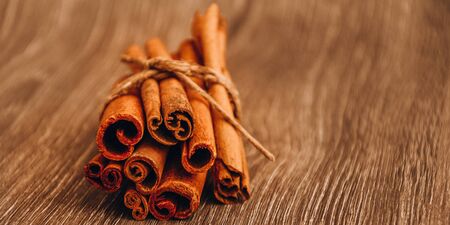 cinnamon sticks on the table, beautiful christmas background with spices, copy space, wood...