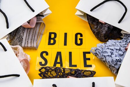 packaging bags, text Big sale on yellow background Top view Flat lay sesonal sale, retail, shopping concept, black friday conceptの写真素材