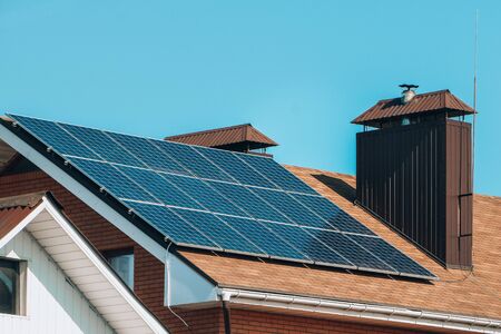 solar panels, Close up shot of a solar panel array with blue sky, Solar panels on a roof for electric power generation, solar panels on houseの写真素材