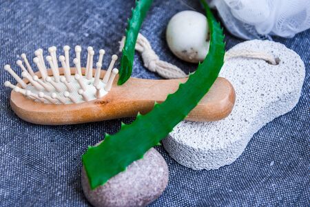 Spa and bath cosmetics with aloe vera. Natural materials in bathroom. Wooden hair brush. Bamboo comb on the dressing table. Eco-friendly hair care products. Natural beautyの写真素材