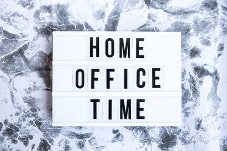 lightbox with text HOME OFFICE TIME in front concrete background, copy space, banner for freelance coronavirus covid-19 quarantine isolation, teleworkingの写真素材