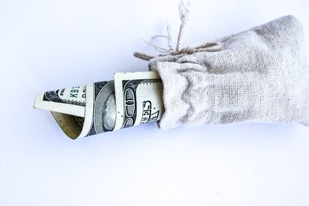 Bag with money isolated on white, Hundred dollar bills in a canvas sack, Banknotes money dollars in the bag, copy space for textの写真素材