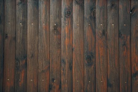 old weathered distressed dark brown wooden boarding wood texture background, dark brown plank fence...