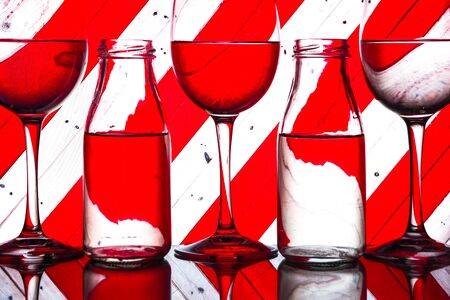 three alcoholic glass in the club entourage, copy space, red background, white, red or rose wine, alcohol drinksの写真素材