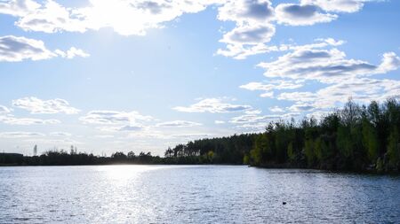 Beautiful landscape with a lake and clouds, trees in forest, Beautiful cloudy sky over a small lake...
