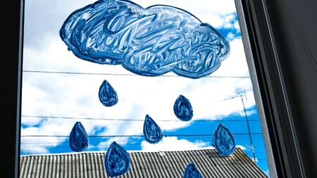a bright painted clouds and drops on the window, from the window you can see a beautiful blue sky with clouds. everything will be alrightの写真素材