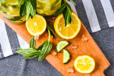 Fresh cool lemon cucumber mint infused water detox drink, summer refreshing drink, organic vegan beverage, selective focus, top viewの写真素材