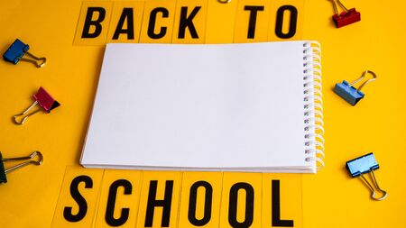 Text Back to school Mock up notebook and office accessories on yellow background with copy space,...