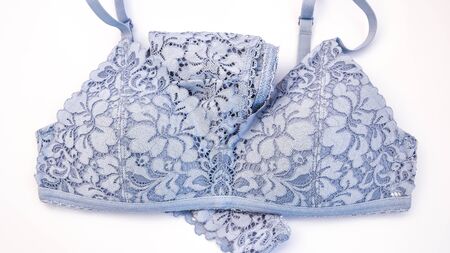 lacy blue lingerie womens underwear on white background, Sexy women's underwear and cotton flowers on white background, top view, shadowsの写真素材