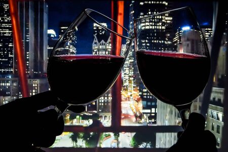 red wine against night life of the city, drinking alcohol, selective focus, copy space, night lights, party timeの写真素材