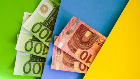 Cash Money on colorful background, Fan of 100 euro bills on color background, copy space for you text, Save and money cocnceptの写真素材