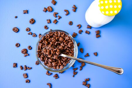 Chocolate cornflakes in the shape of letters of the English alphabet for a quick breakfast with milk...