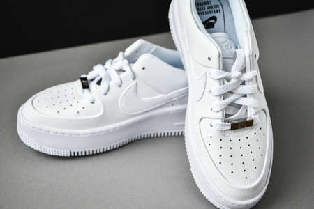 Zhytomyr, Ukraine - June 1, 2020: Nike Air Force 1 Sage white sneakers product shot on gray background. Illustrative editorial photo. Sport footwearのeditorial素材