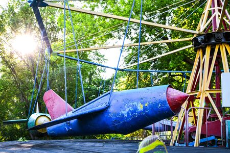 An empty playground in park, which is forbidden to visit during the quarantine period of the pandemic of COVID-19 disease caused by coronavirus, Lone swings in the children's parkの写真素材