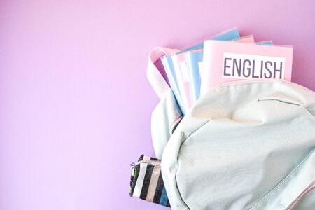 Flat lay composition with backpack and school supplies and subject books on color background. copy space, english biology physicsの写真素材