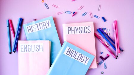 School subject books with supplies on color background, back to school. Stationery ruler pencil paper clips work placeの写真素材