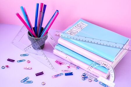 School subject books with supplies on color background, back to school. Stationery ruler pencil paper clips work placeの写真素材