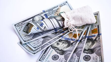 Bag with money isolated on white, Hundred dollar bills in a canvas sack, Banknotes money dollars in the bag, copy space for textの写真素材