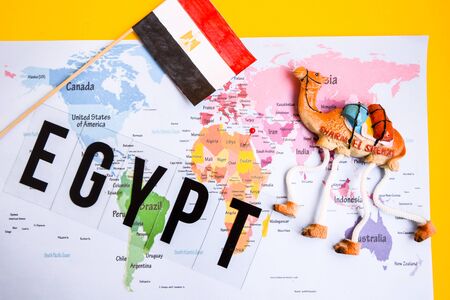 Egypt travel concept, camel magnet, egypt flag over world map, boarding pass with passportの写真素材