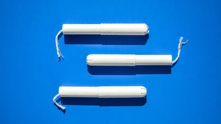 Hygienic tampons on a blue and purple background. copy space, Menstruation sanitary tampon for woman...