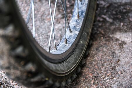close-up bicycle wheel on road, selective focus, Bicycle wheel close up against the background of a...