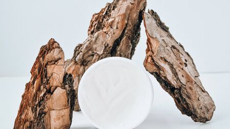 The concept of natural and natural cosmetics for personal care. Cream on a tree bark. beauty fashion cosmetic makeup spa cream lotion cleanser facial foamの写真素材
