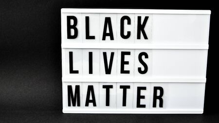 BLACK LIVES MATTER text on a black background. Freedom of Speech Vintage Retro quote board. Protest against the end of racism, anti-racism, equality. Poster on violation of human rightsの写真素材