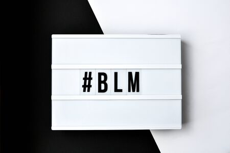 hashtag BLM BLACK LIVES MATTER text on a black and white background. Freedom of Speech Vintage Retro quote board. Protest against the end of racism, anti-racism, equality. Poster on violation of human rightsの写真素材