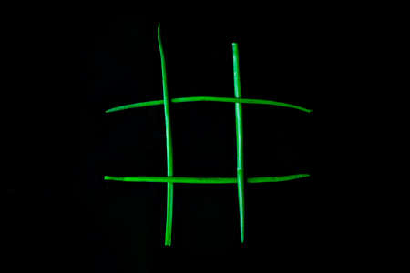 Diet concept hazardous game for health tic tac toe made of tomatoes cucumbers and green onion, vegan...