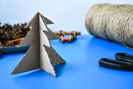 Top view of Making little Christmas tree of cardboard. Children's art project, a craft for children. DIY concept. Step by step 6. Natural Christmas handmade decorations. Zero waste christmasの写真素材