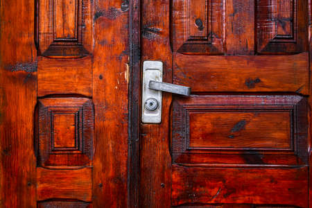 Door knob on a wooden door, wooden door with lock and knocker, old woodの写真素材