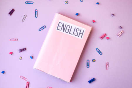 school book. English with supplies stationery on color background, back to school, ruler, pencilsの写真素材