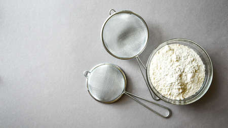 Flour prepared for baking on gray background. Copy space for text. Recipe ingredient