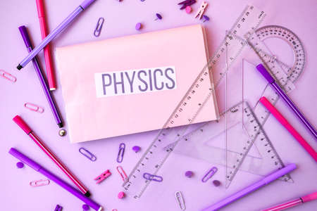 school book. physics with supplies stationery on color background, back to school, ruler, pencils