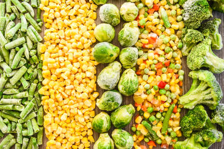 Different frozen vegetables as background, top view. Stocking up vegetables for winter storage. Assortment of frozen vegetables. Healthy food, Cooking ingredientsの写真素材